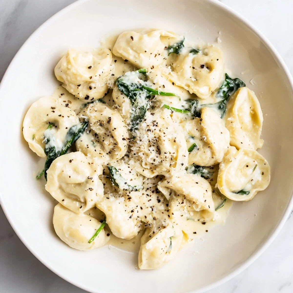 Creamy spinach Alfredo tortellini, a comforting Italian dinner with cheese tortellini and a rich, creamy sauce.