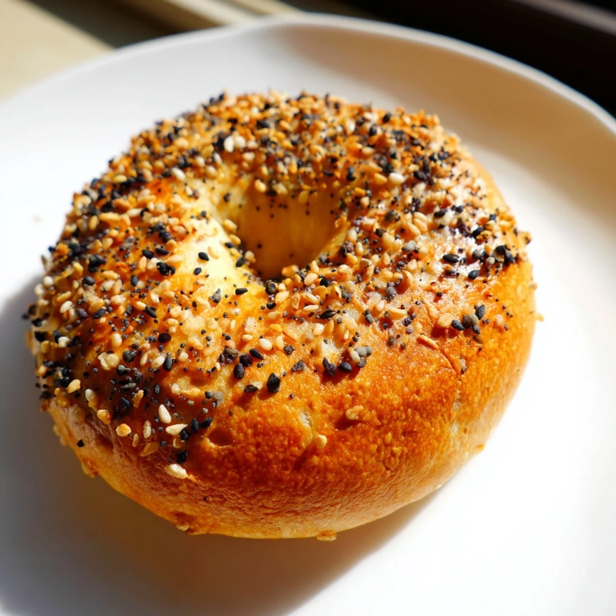 Golden, perfectly baked homemade budget bagels, ready to be slathered in cream cheese at breakfast.