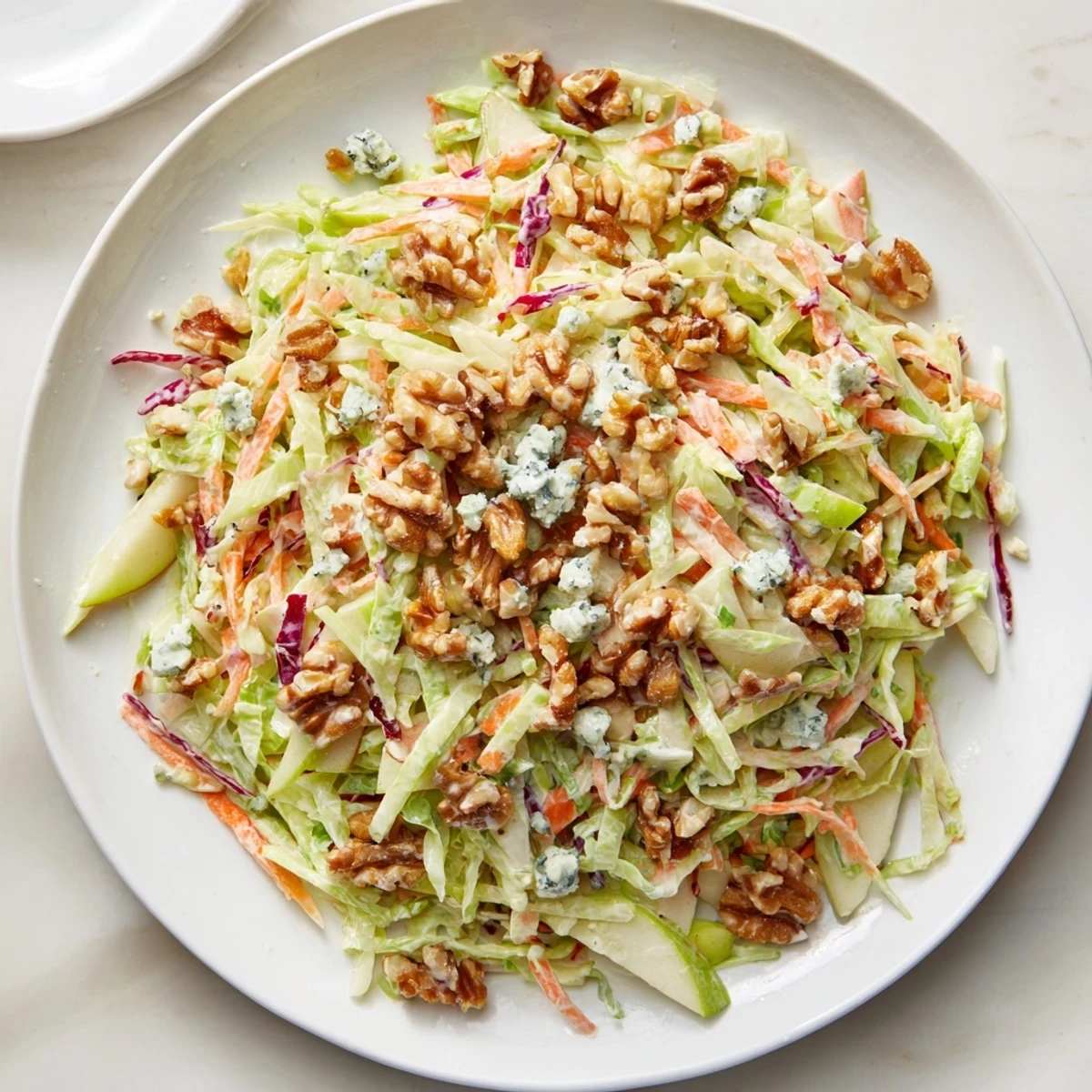 Fresh Crunchy Apple & Walnut Slaw with blue cheese, ready to serve in a bright, colorful bowl.
