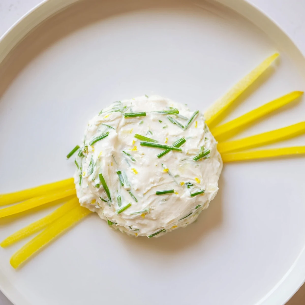 Yellow bell pepper sunburst with creamy lemon goat cheese and crisp breadsticks. A Tuscan Sunburst appetizer ready to enjoy.