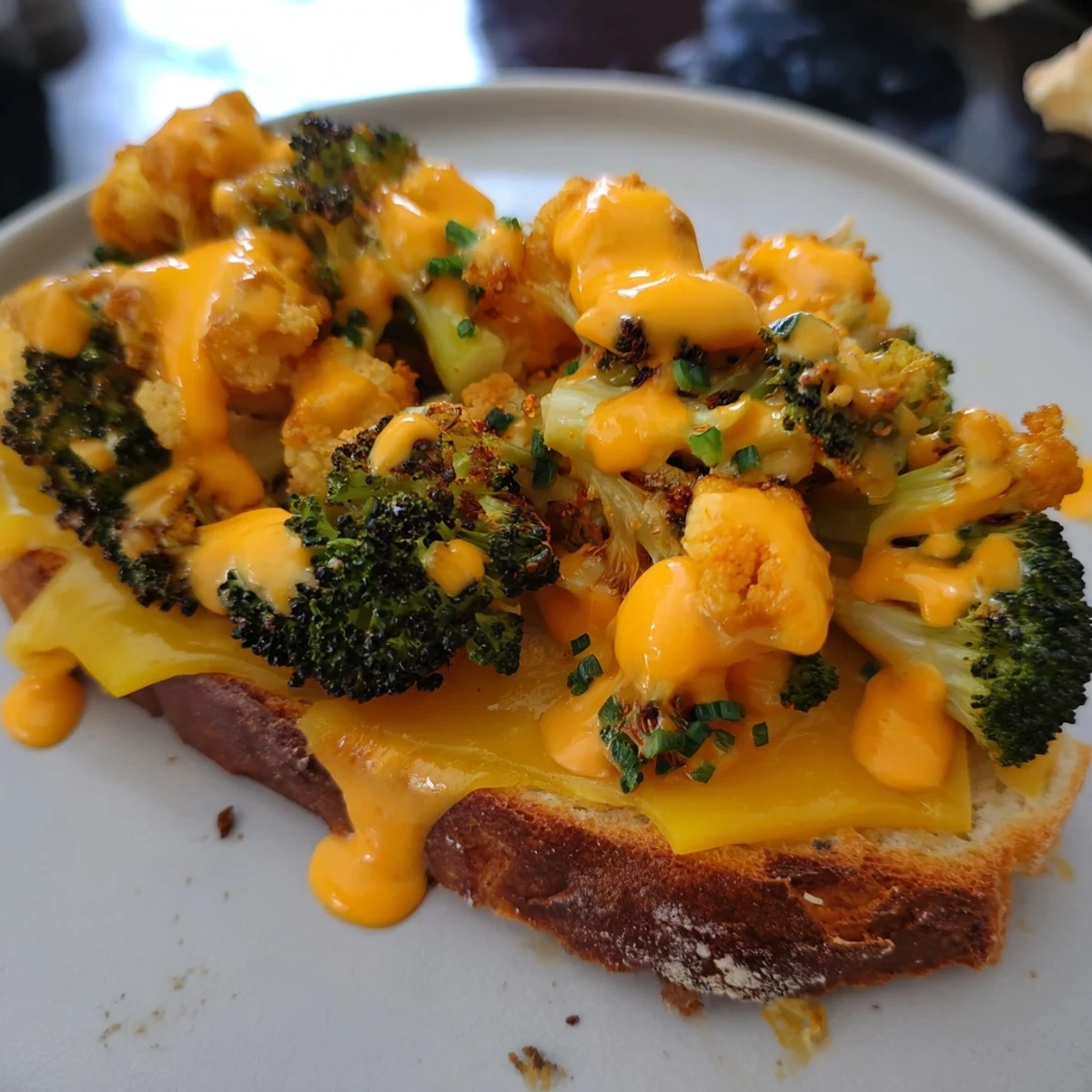 Buffalo Cauliflower Ranch Grilled Cheese with melted cheese oozing from golden, toasted bread.