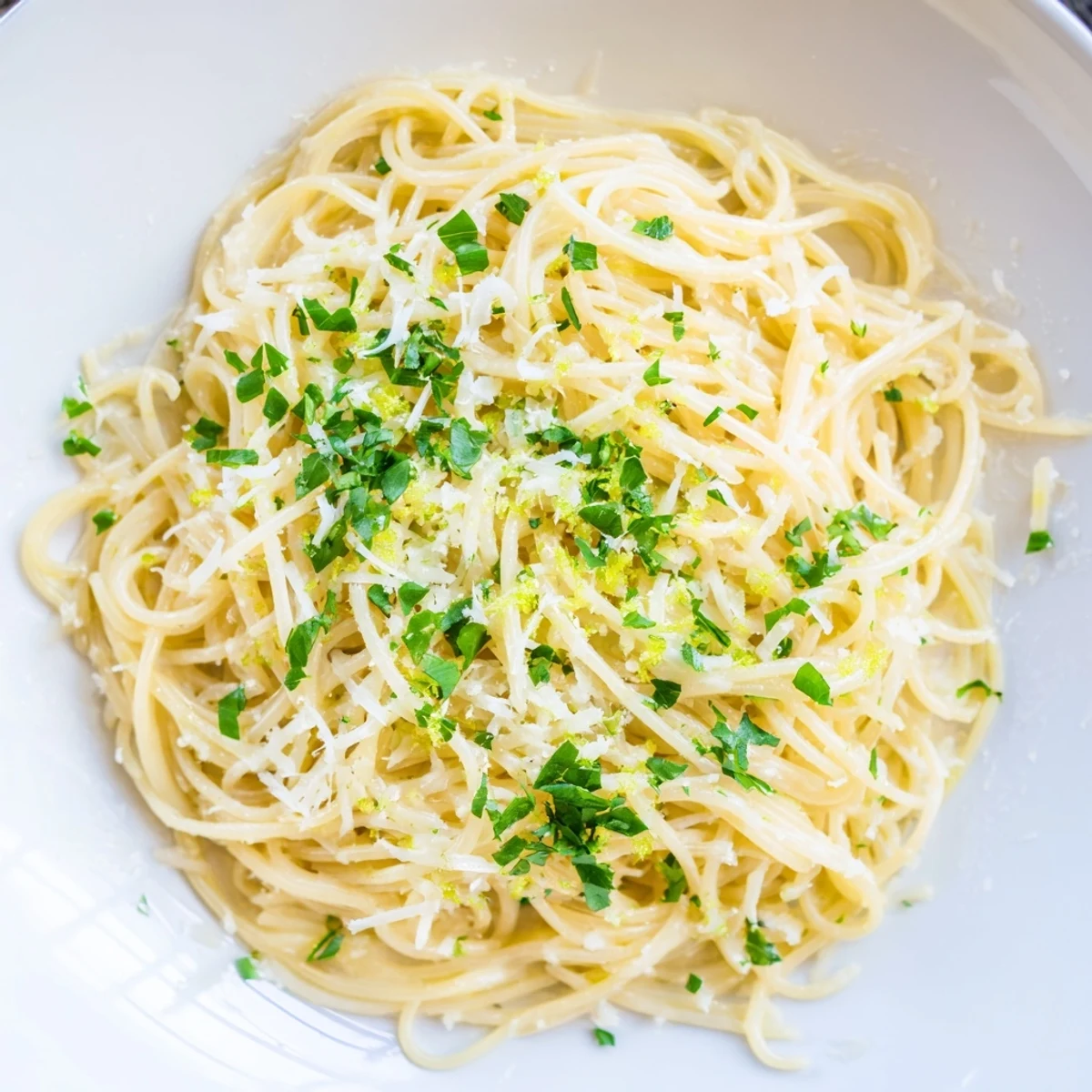 Steaming plate of Lemon Capellini with Fresh Herbs, its zesty sauce clinging to delicate pasta strands.