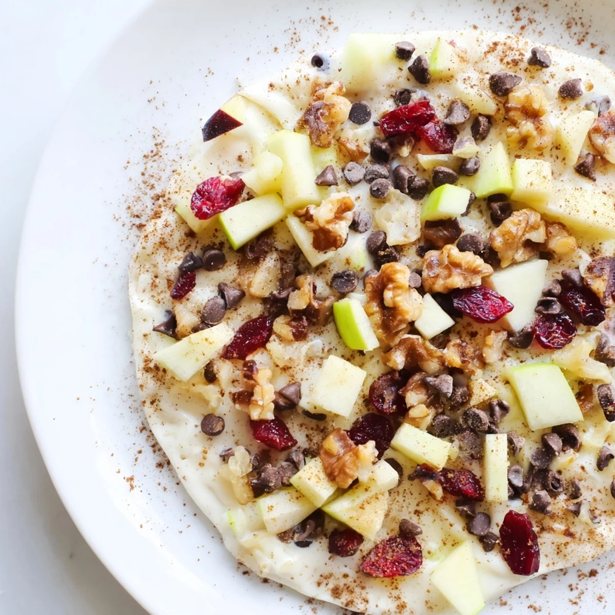 Frozen Apple Cinnamon Yogurt Bark with a sprinkling of cinnamon and delicious toppings, a perfect dessert.