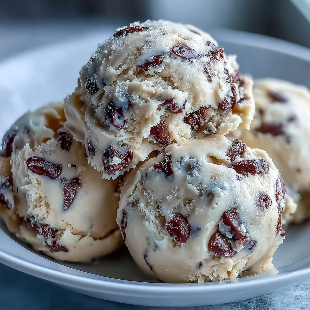 A scoopable bowl of Greek Yogurt Cookie Dough, featuring creamy butter and tangy yogurt with mini chocolate chips.