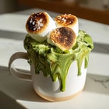 A steaming mug of toasted marshmallow campfire matcha hot cocoa, offering cozy warmth.