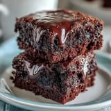 4th of July Firecracker Brownie Bites with creamy frosting and patriotic sprinkles on a festive platter.  