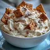 Sweet and fluffy cheesecake dip served chilled with crunchy graham crackers for dipping.