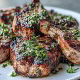 Elegant lamb chops with zesty mint gremolata, perfect for a festive Mediterranean-inspired dinner.