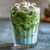 Visually stunning iced matcha latte topped with sweet vanilla cold foam for Mother's Day.