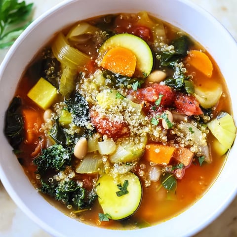 Steaming bowl of Minestrone with Quinoa, garnished with parsley and ready to enjoy.