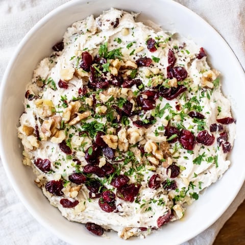Close-up of Lightened Holiday Cream Cheese Dip, showing a creamy texture with cranberry swirls on top.