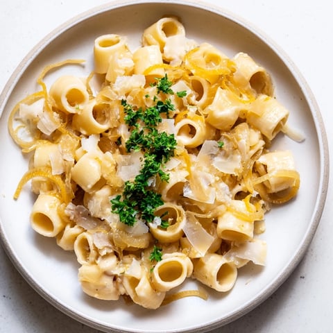 Golden Gruyère melts over Creamy French Onion Ditalini, a comforting vegetarian pasta dish.
