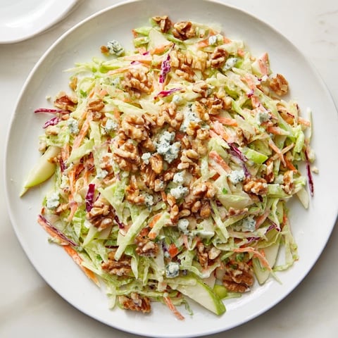 Fresh Crunchy Apple & Walnut Slaw with blue cheese, ready to serve in a bright, colorful bowl.