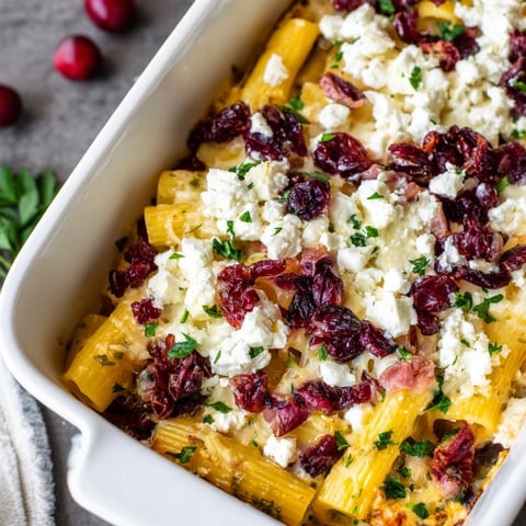 Golden, bubbly Cranberry-Sage Feta Pasta Bake, a delicious vegetarian comfort food with warm, inviting layers.