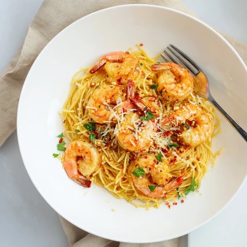 One-skillet lemon garlic shrimp angel hair pasta, a sizzling skillet meal with juicy shrimp and fragrant garlic.