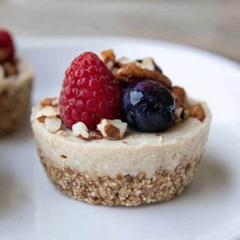 Creamy Protein Cheesecake Cups topped with fresh berries, ready to enjoy as a flavorful treat.
