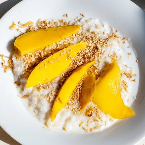 Sweet, vibrant slices of juicy mango alongside creamy coconut Thai Mango Sticky Rice.