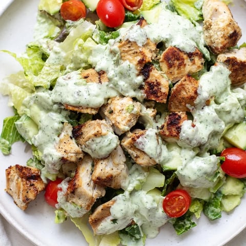 Sliced grilled chicken and diced veggies tossed in creamy avocado ranch dressing on mixed greens, perfect for a light lunch.