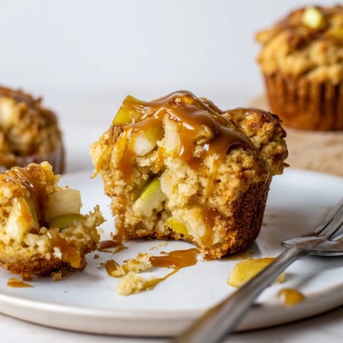 Golden-brown scone muffins bursting with fresh apples and topped with decadent caramel.  
