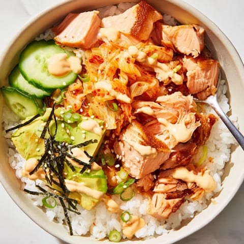 Delicious Crispy Salmon Rice Bowl with crispy skin, fluffy rice, and tangy kimchi.  