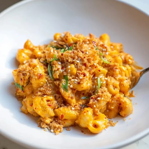 Indulge in Spicy Kimchi Mac & Cheese topped with golden panko and sesame seeds.  