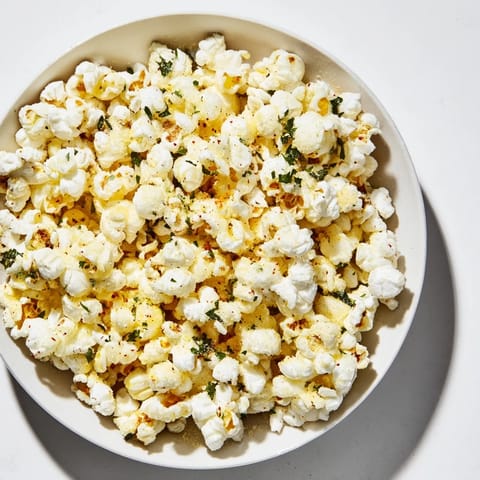 A bowl overflowing with flavorful savory popcorn mixes, perfect for sharing at parties.