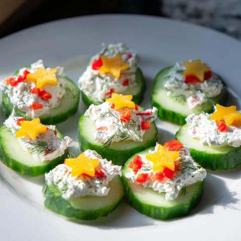 Enjoy a close-up of beautifully arranged Holiday Star Cucumber Bites, perfect for Christmas or holiday parties.