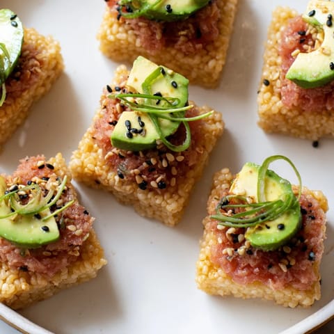 Close-up photo of savory spicy tuna crispy rice, showing a beautiful contrast of textures and flavors.