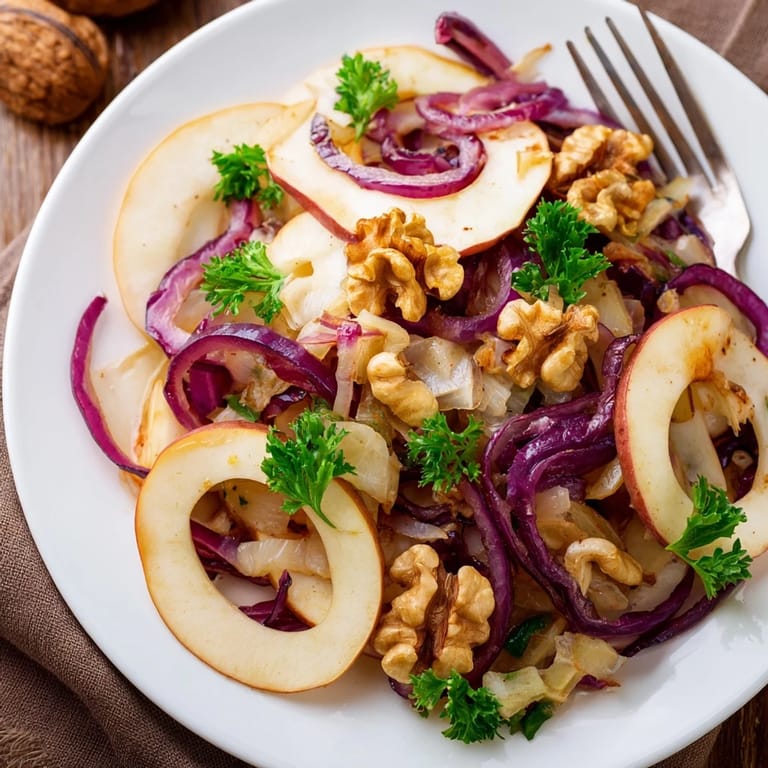 Warm apple and sauerkraut skillet salad served in a bowl with toasted pecans, ready to enjoy as a comforting, gut-healthy side dish.