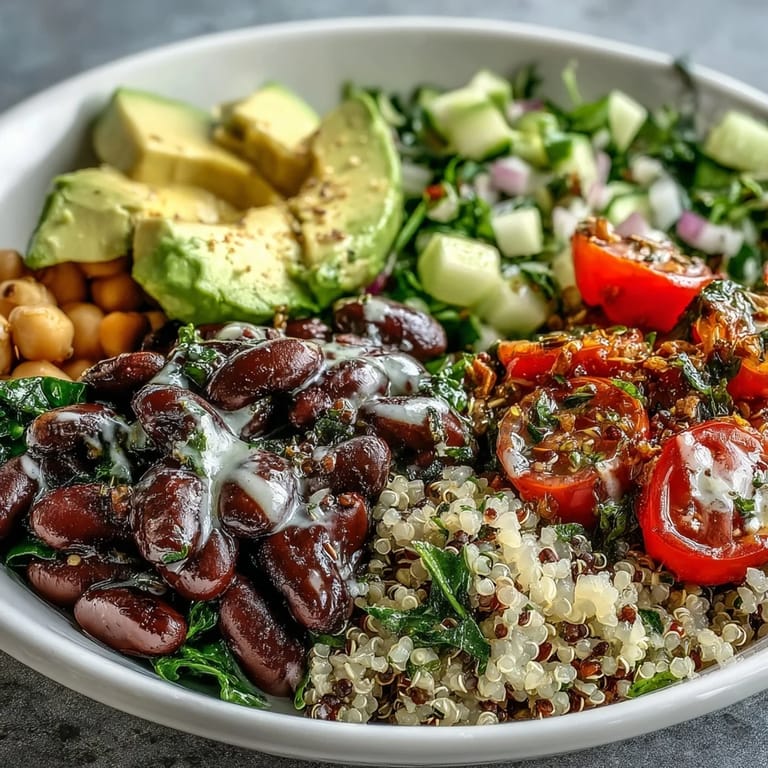 Colorful Three-Bean Power Bowl garnished with cherry tomatoes, cucumbers, and cilantro, ready for a healthy lunch or dinner.